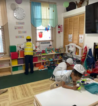 Children in dress-up costumes playing in the Happy Little Hearts playroom